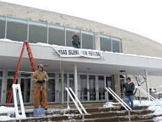 Lyle Waring and grounds crew clean concert hall steps of snow on Friday afternoon.