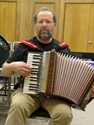 Rodney Sauer practices for his first Kansas performance with an accordian