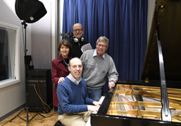 Group at live broadcast piano
