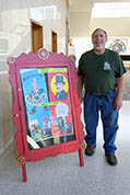  Larry Sangles of Hutchinson, KS, poses beside this year's display-case