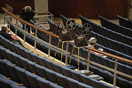 16mm film projectors are set-up at the edge of the balcony area, White Concert Hall